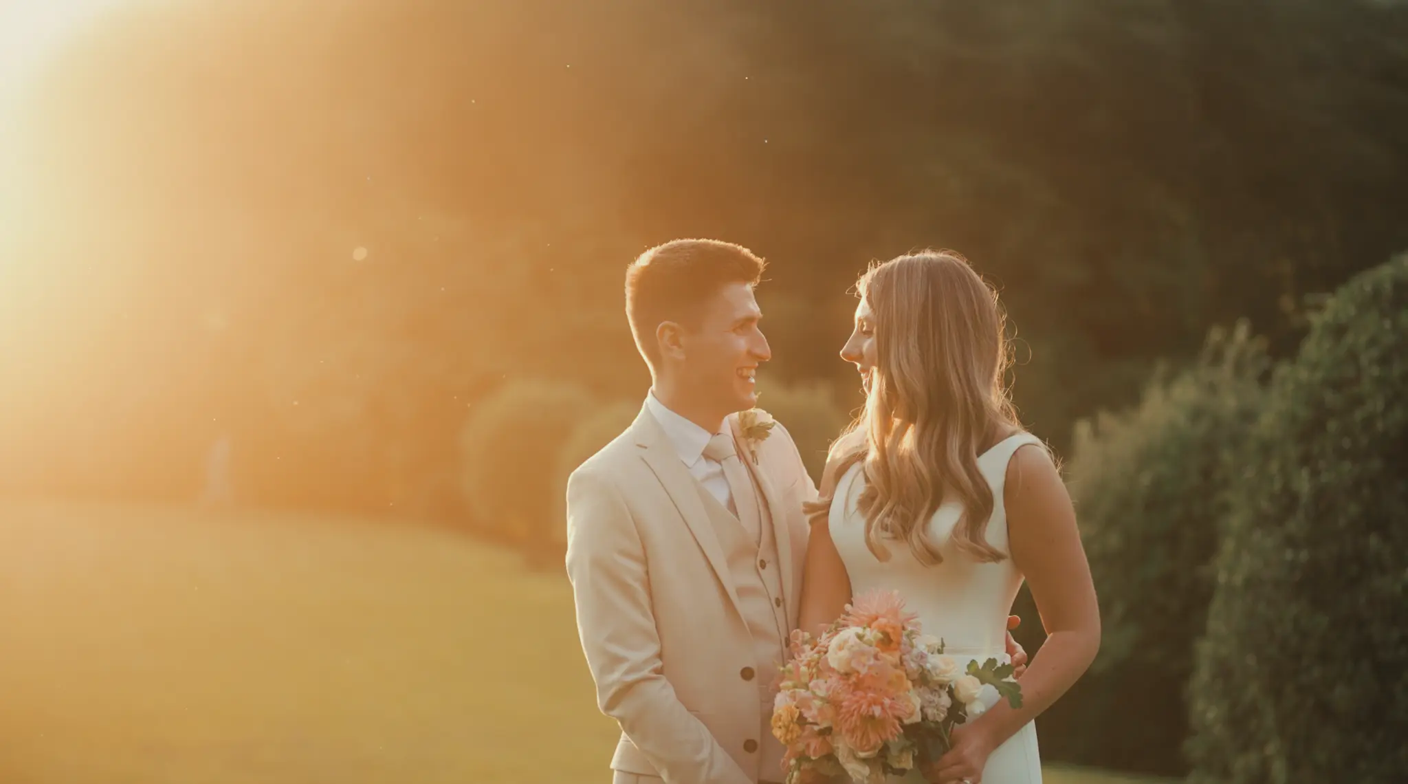 Newlyweds together in warm golden-hour light